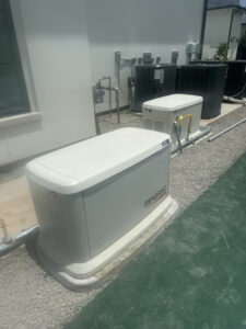 Licensed electricians installing a standby generator at a Houston home